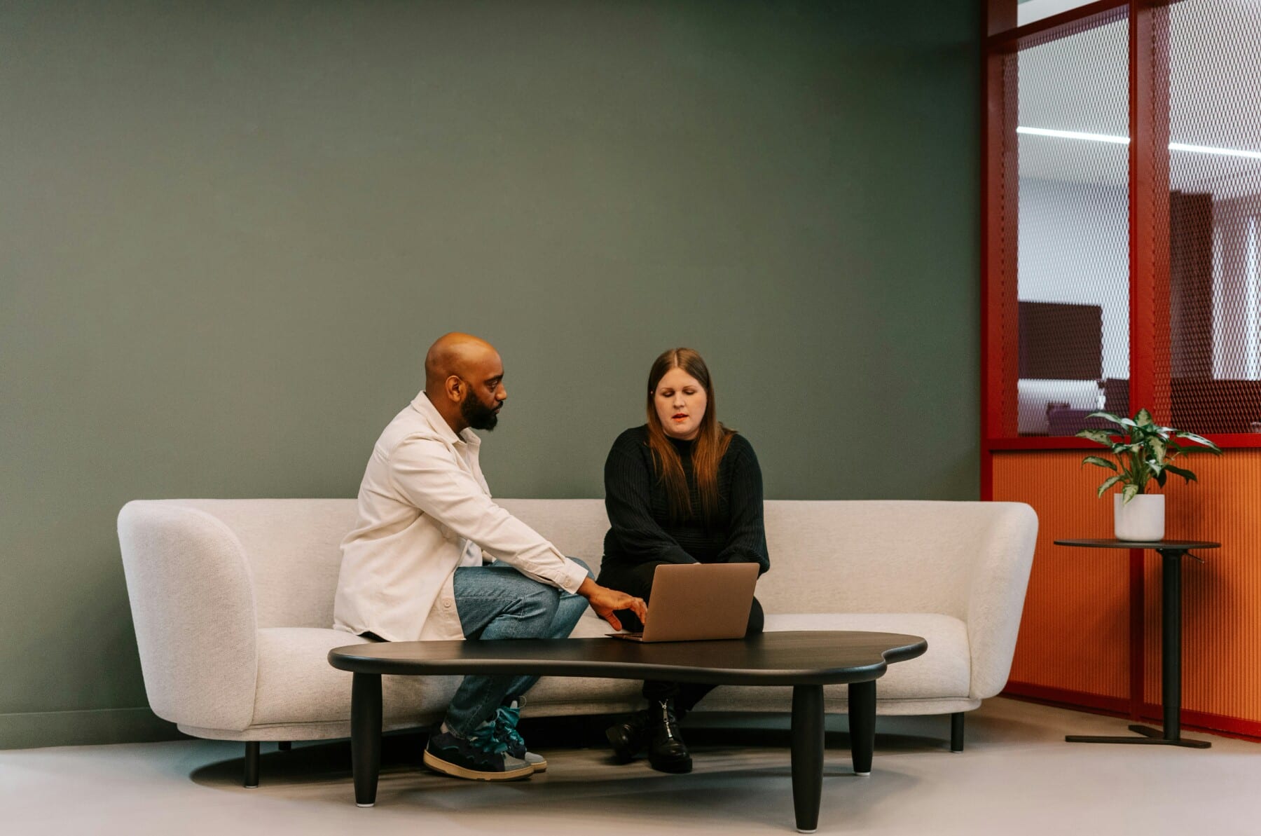 Two colleagues reviewing event spend on a laptop